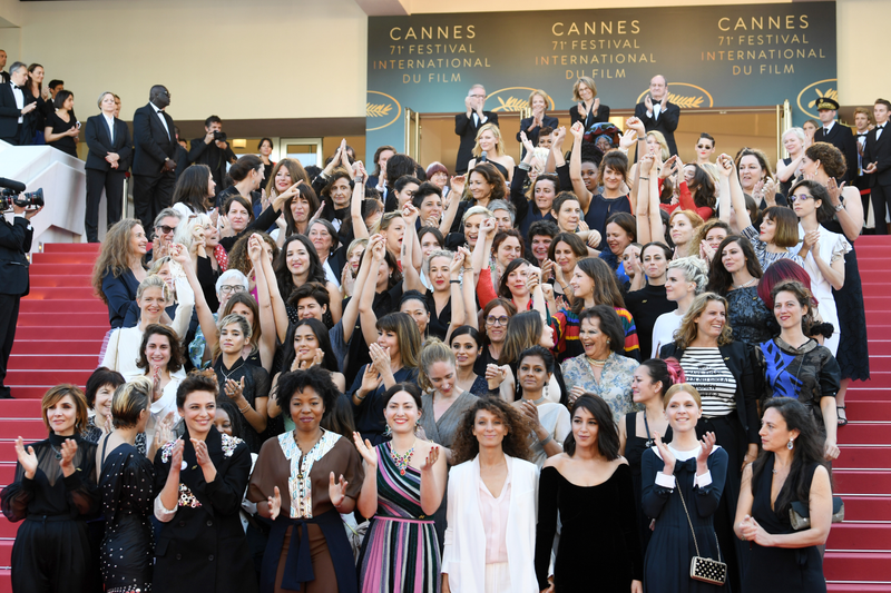 Filmmakers clap after jury head Cate Blanchett, with other filmmakers, read a statement on the steps of the red carpet in protest of the lack of female filmmakers honored throughout the history of the festival.